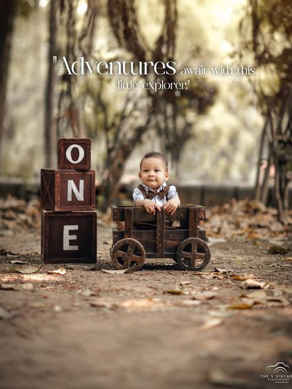 This little explorer is ready for adventure in his wooden wagon. Our outdoor first birthday sessions in the park are perfect for capturing a rustic, natural feel.