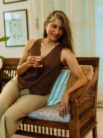 A close-up of the handloom waistcoat, paired with a statement necklace for a touch of glamour.