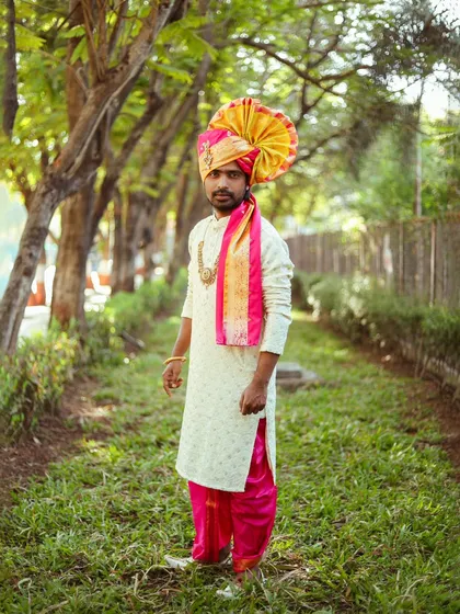A full-length shot of the groom, capturing his complete traditional look from head to toe.