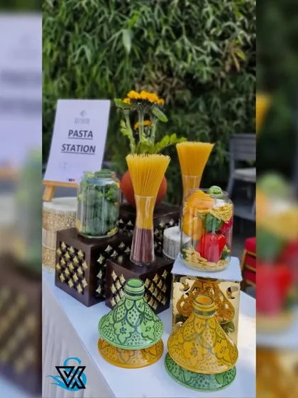 Even the food stations were part of the decor. Here, a pasta station is decorated with colorful vegetables in glass jars and traditional painted serveware, blending international cuisine with local artistry.