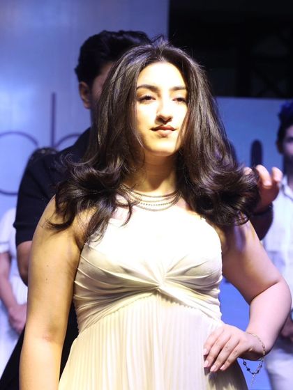 A model on stage at the Beautech Expo, showcasing a soft, voluminous style. Live shows allow me to demonstrate a wide range of looks, from edgy to elegant.