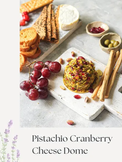 Our Pistachio Cranberry Cheese Dome. This image showcases the beautiful contrast of green pistachios and red cranberries on this sweet and savory cheese dome.