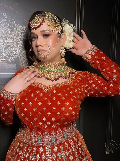 An extensive series from a bridal demo, showcasing a red velvet Anarkali-style lehenga. This is a valuable resource for MUAs learning to create a classic bridal look.