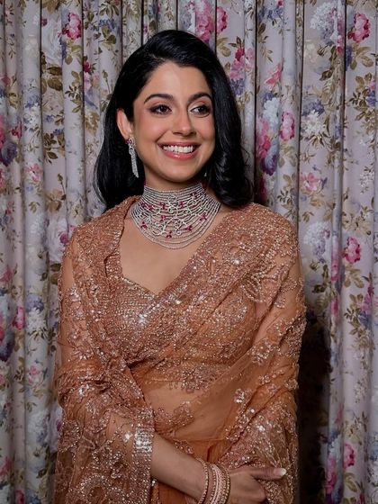 A beautiful portrait of this bride's cocktail night elegance. The makeup is polished and refined, letting her natural beauty and joyful expression take center stage.