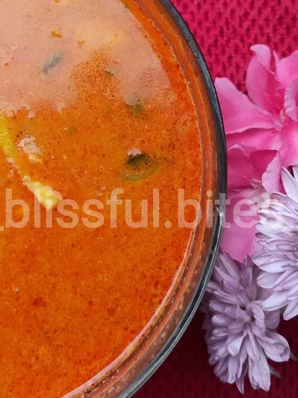 The rich, orange hue of my Thai Red Curry, a testament to the authentic spices and coconut milk I use to create this delicious dish.
