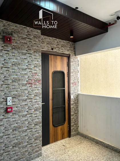 The entrance sets the tone for the entire home. I designed this main door with a modern mix of wood and metal, complemented by a textured brick-cladding wall to create a grand and welcoming first impression.