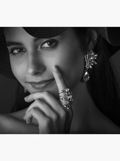 A classic black and white glamour portrait, highlighting fine jewelry and a captivating expression. This style is perfect for models, actors, and professionals in the beauty and fashion industries seeking a sophisticated portfolio piece.