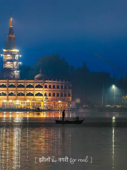 "Jheelon ki nagri for real." A serene night shot of a temple by the lake in Bhopal, reflecting the city's title as the City of Lakes.