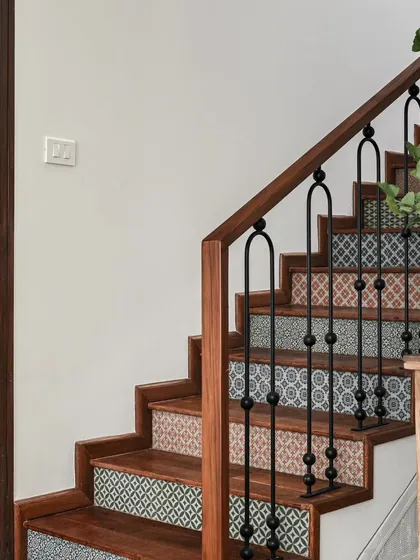 Details matter. For this Modern Spanish home, I designed the staircase to be a work of art, using varied patterns of cement tiles on the risers and custom black iron railings with an arch motif. It’s these thoughtful touches that carry the home's narrative through every corner.