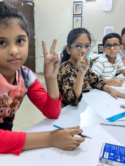 A group of young students posing for a quick photo during their drawing class. The peace signs say it all, they're having a great time!