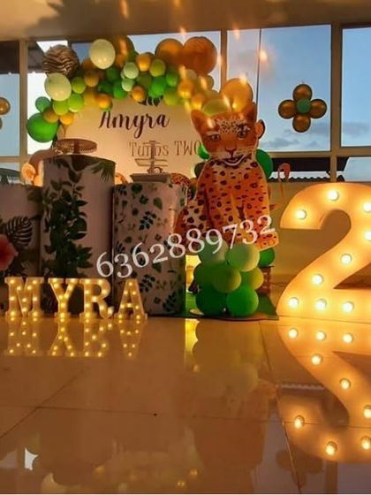 A jungle theme setup on a rooftop, with the city lights in the background adding a unique ambiance to the celebration.