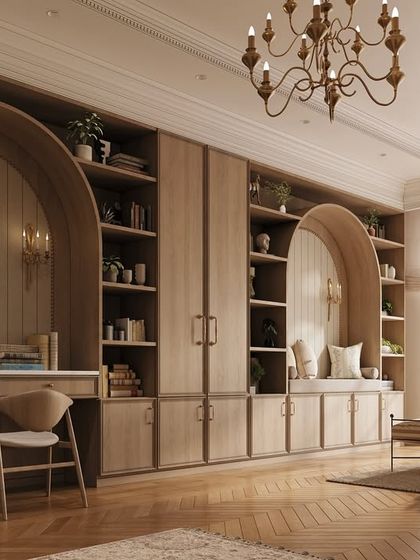 Functionality meets elegance with this custom built-in wall unit. It incorporates a study desk, a reading nook, and ample shelving, all framed by beautiful arched details that elevate the design.