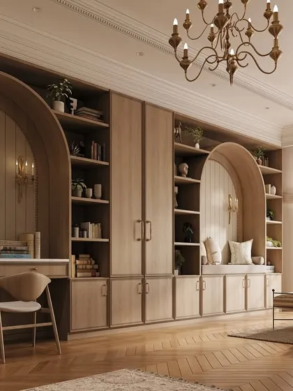 Functionality meets elegance with this custom built-in wall unit. It incorporates a study desk, a reading nook, and ample shelving, all framed by beautiful arched details that elevate the design.