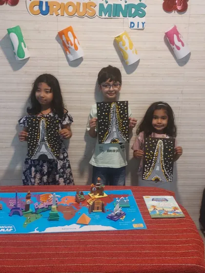 Proud artists with their sparkling Eiffel Tower paintings. This activity was part of our "Wonders of the World" theme, where we learned about famous landmarks and then recreated them with a creative twist.