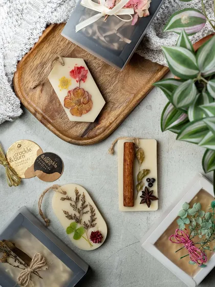 A collection of my wax tablets, showcasing the different botanical arrangements I can create. From cinnamon sticks to pressed flowers, each one is unique.