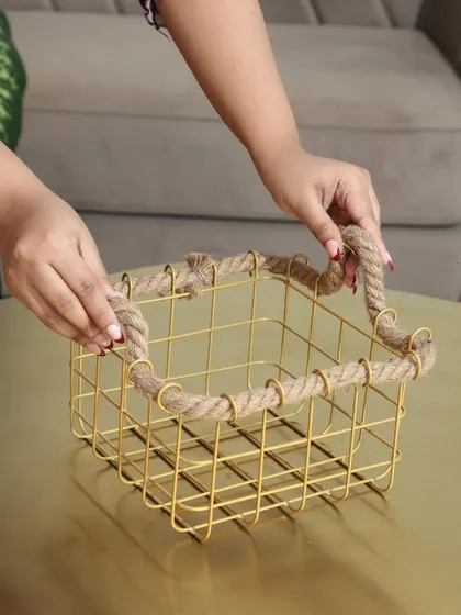 Our gold wire basket with a rustic rope-trimmed edge. This piece combines industrial and nautical elements for a unique and stylish storage option.