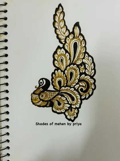 An elegant peacock motif created with a mix of bold and fine lines. This is a classic element in Indian mehendi that we practice in various styles.