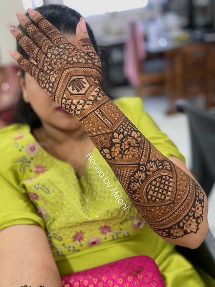 A lovely engagement mehendi design, with a heart-shaped central pattern and full coverage on the arm.