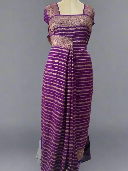 A mannequin draped in a purple pure Banaras crepe saree with stripes.