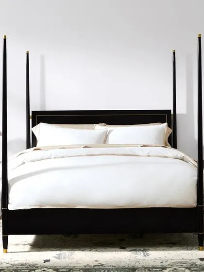 A frontal view of the Los Angeles four-poster bed, showcasing its pleasing proportions and the subtle elegance of the brass trim on the headboard.