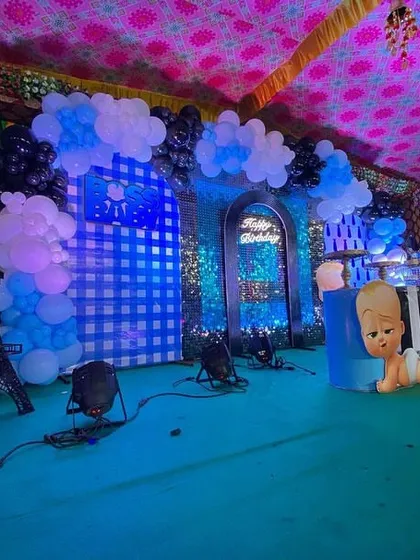 A side view of the Boss Baby stage, showing the Eiffel Tower prop and the layered backdrop design with checkered and sequin panels.