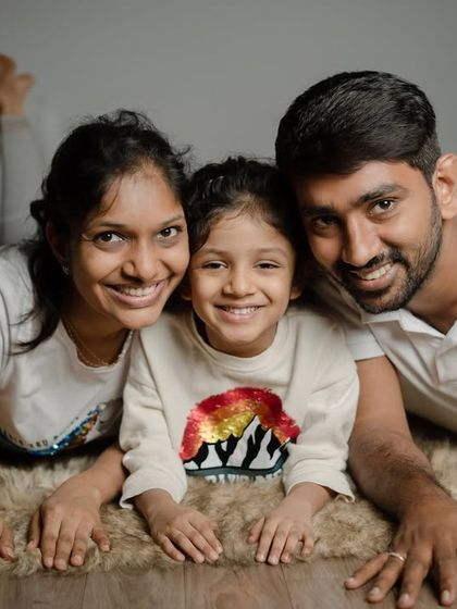 A beautiful family portrait taken at our studio. We create a relaxed atmosphere where families can lie down, get close, and share a genuine moment of connection for the camera.