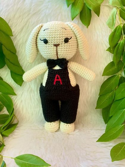 A dapper boy bunny! This little buck looks so smart in his black overalls with a personalized initial and a matching bow tie.