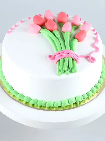 A cake that looks like a bouquet of flowers. This design features a beautifully piped bunch of pink tulips, making it an elegant and artistic choice for birthdays, anniversaries, or to simply say thank you.