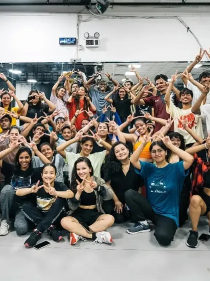 The Allstars tribe making the signature 'A' sign. A symbol of our community and the family we've built through dance.