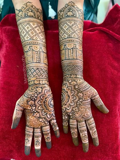 The full design on a red background, highlighting the intricate bands and patterns on the forearms.