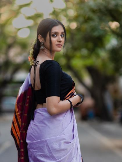 A look that will make them stop and stare. The back view shows the simple yet elegant tie-up blouse, a perfect match for the traditional saree.