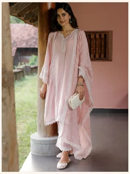 This pale pink kurta set is the definition of understated elegance. The clean silhouette and delicate lace trim make it a versatile piece for any occasion.