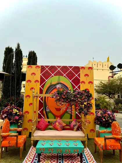 For this Mehendi, I used vibrant pop art featuring traditional Rajasthani figures to create a fun and quirky photo backdrop. It's about adding personality and a touch of the unexpected to the decor.