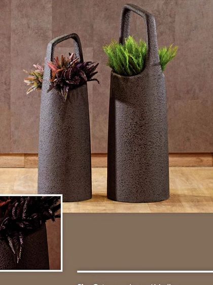 These unique, bag-shaped planters with handles are a quirky and stylish choice. Their textured, dark finish adds a rustic yet modern touch to any plant arrangement.