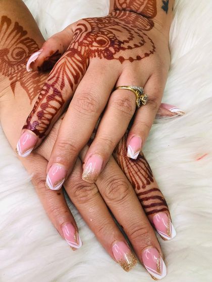 A closer look at the geometric French tip design. The clean white lines and subtle gold sparkle create a sophisticated nail look perfect for a contemporary bride.