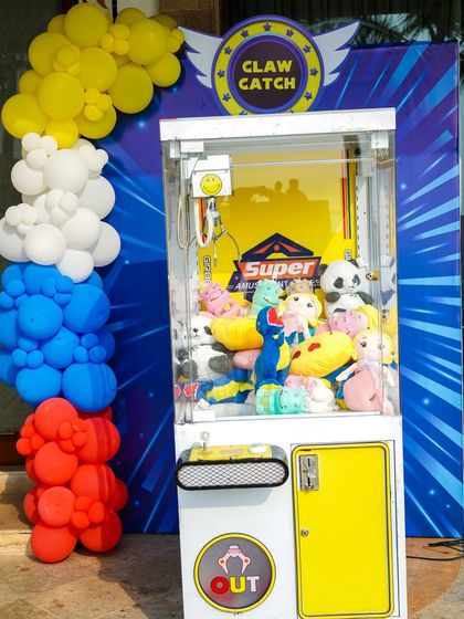 A classic claw catch machine filled with plush toys, offering guests a chance to win a prize to take home.