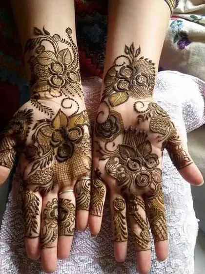 This design is a beautiful fusion of styles, with bold, modern flowers on one hand and more traditional, intricate patterns on the other.