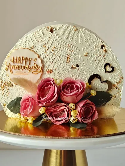 My first time creating a "cake top forward" design, and I'm in love with the result. This anniversary cake features delicate stenciling on whipped cream, gold leaf, and a beautiful arrangement of pink artificial flowers.