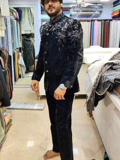A full-length view of the client in the navy blue velvet Jodhpuri, showcasing the complete, elegant look.