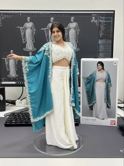 This white and teal Indo-Western outfit with a hand-embroidered cape is one of our signature styles, now immortalized as a collectible figure.
