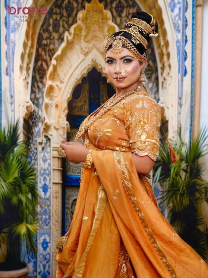 A student's creation of a Madhubala-inspired look, featuring a towering traditional bun, heavy gold jewelry, and classic makeup.