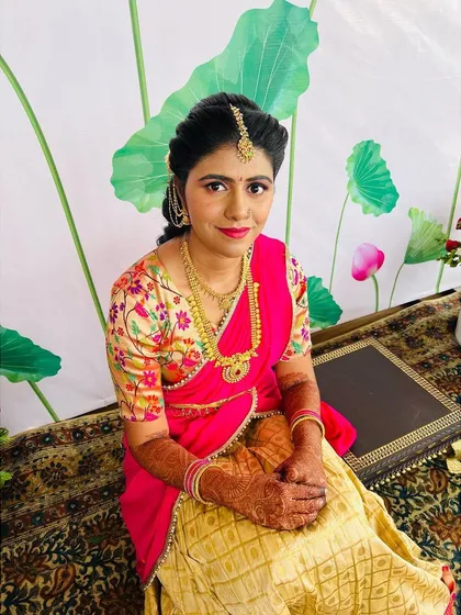 A close up of the bride's second look for her Pellikuthuru. The floral blouse and pink half saree are so pretty and youthful.