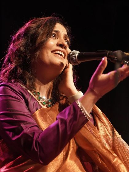 Another performance shot, capturing the passion of the artist and the richness of her attire.