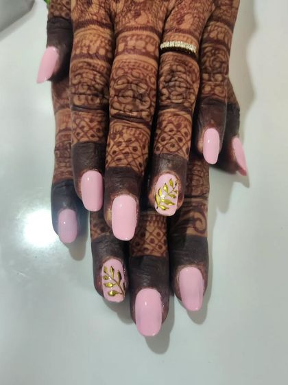 Elegant and understated temporary bridal nails. This set features a soft baby pink on square-shaped nails, with delicate golden leaf art on the accent fingers to match the bride's henna and jewelry.