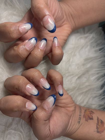 This design features a deep blue French tip on an elegant almond-shaped nail. It’s a simple way to incorporate color while keeping the look chic and refined.