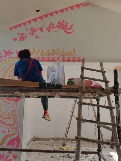 Another angle of me on the scaffolding for the 'Baba's Garden' project. You can see how the patterns are designed to wrap around the architecture, making the art a true part of the building.