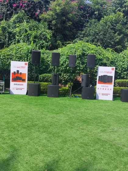 A lineup of various JBL Professional speaker systems on display at a product demonstration event. We offer a wide range of audio solutions, from compact portable speakers to large-format line arrays, to fit any event size and need.