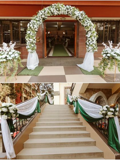 The entrance to Ryan and Ela's wedding was decorated with a classic white floral arch and simple, elegant drapes on the staircase, creating a sophisticated and welcoming first impression.