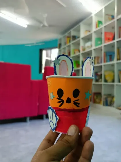 A close-up of a bunny craft made from a paper cup. These simple, creative activities reinforce the values from our stories and give children a tangible reminder of the lessons learned.