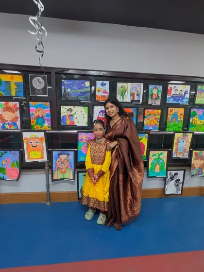 A proud moment between a student and her mentor in front of a wall of vibrant artwork. This photo embodies the Guru-Shishya bond we cherish, celebrating the journey of learning and creativity together.